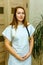 Smiling european woman physician with stethoscope in a white uniform. Portrait of a young medical worker with positive attitude.