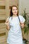 Smiling european woman physician with stethoscope in a white uniform. Portrait of a young medical worker with positive attitude