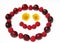 Smiling face, formed of berries and flowers