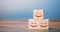 Smiling faces on wooden blocks. Feedback, critic`s assessment, service rating, ranking, customer reviews concept. Satisfaction an