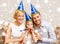 Smiling family in blue hats blowing favor horns