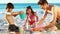 Smiling family building sand castles