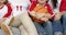 smiling family with grandmother watching basketball match