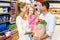 Smiling family with grocery bag at the supermarket