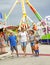 Smiling family having fun at an outdoor summer carnival