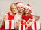 Smiling family holding gift boxes and sparkles