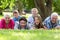 Smiling family lying in the grass