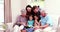 Smiling family reading book together on sofa