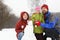 Smiling family and snowman