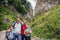 Smiling family standing on a rugged trail while hiking together