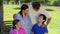 Smiling family standing upright together