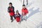 Smiling Family Throwing Snow Up in the Air in Ski Resort