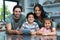 Smiling family using tablet in the kitchen