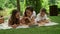 Smiling family watching movie on tablet outdoors. Family using computer outside