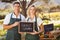 Smiling farmer couple holding locally grown sign