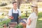 Smiling farmer discussing with a blonde customer