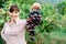 Smiling farmer holding grapes