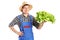 A smiling farmer holding a lettuce in his hand