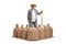 Smiling farmer with a wooden tool standing behind burlap sacks