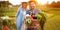 Smiling farmers couple with vegetables in basket