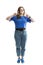 A smiling fat young girl in blue Mayenne and jeans stands and shows a victory sign. Full height. Eared on a white background.