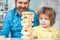 Smiling father and focused son playing jenga game at home. Individual tutoring. Elementary school.