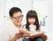 Smiling father and her daughter reading a book