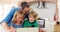 Smiling father and kids using laptop