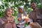 smiling father, mother and daughter lighting fireworks together