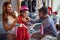 Smiling father and mother shopping new bicycle and helmets for little girl in bike shop