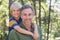 Smiling father piggybacking son in forest