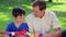 Smiling father and son looking at a kite