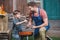 Smiling father and son preparing grill for barbecue