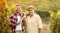 Smiling father and son tasting wine in vineyard