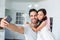 Smiling father taking self portrait with daughter in fairy costume