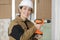 Smiling female builder with drill tool