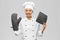 smiling female chef in jacket with potholders