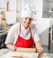 Smiling Female Chef Rolling Pasta Sheet At Counter