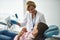 Smiling female dentist holding a dental radiography scan