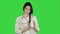 Smiling female doctor looking at camera and holding bottle of pills on a Green Screen, Chroma Key