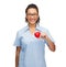 Smiling female doctor or nurse with heart