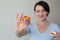 Smiling female doctor offering orange drugs