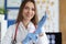 Smiling female doctor putting on medical gloves