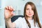 Smiling Female doctor in white coat with stethoscope holding a pill between her fingers. Hand of a hospital medical expert shows t