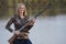 Smiling Female Duck Hunter with shotgun