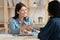 Smiling female employer handshake job candidate at briefing