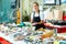 Smiling female fishmonger offering fresh sea bass