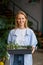 Smiling female florist worker enjoying her job