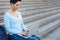 Smiling female freelancer working on a laptop outdoors