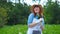 Smiling female gardener posing with zucchini plants and looking at camera, farming and gardening concept